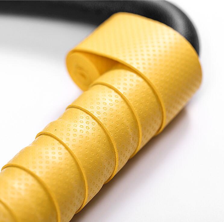 Close-up of gymnastic ring with yellow strap wrap and reinforced connection for durability